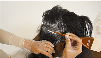 Relaxer-being-smoothed-blended-into-hair-step-by-step-tutorial