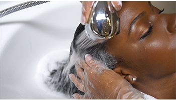relaxer-hair-being-rinsed-mizani
